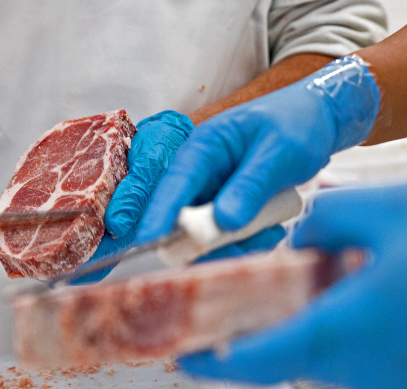 Beef being handled with gloves