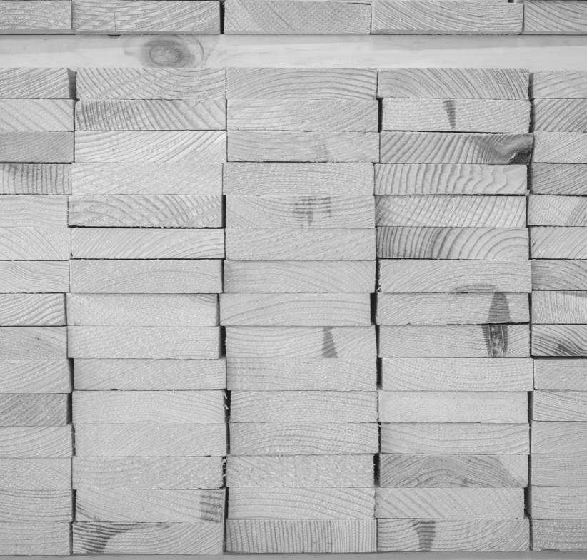Stacked dimensional lumber at a lumber manufacturing site