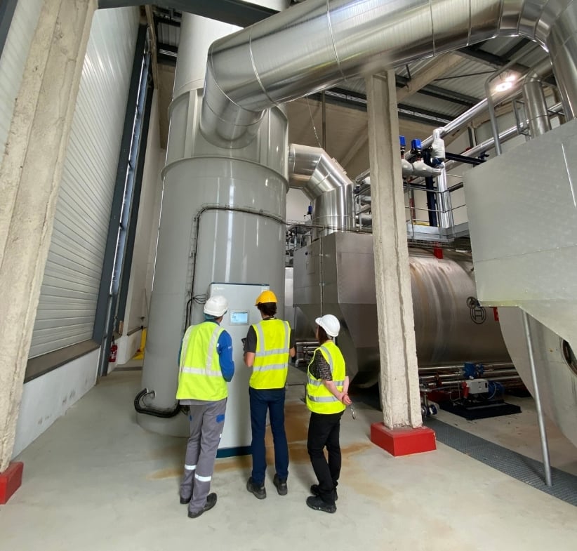 TEI Engineers looking at a FLU-ACE control panel